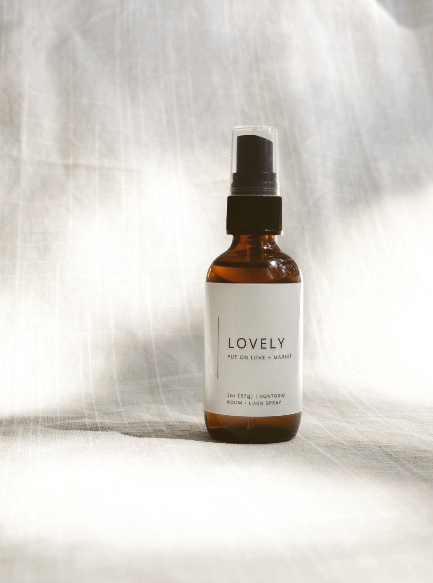Room & Linen Spray on a white bedding and has a scent called LOVELY